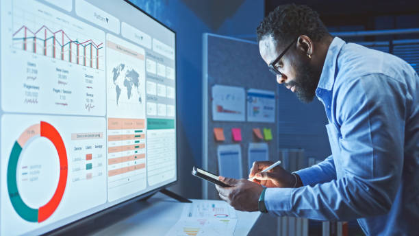 A Man Reviews the Data Analysis of Marketing from Social Media Platforms.